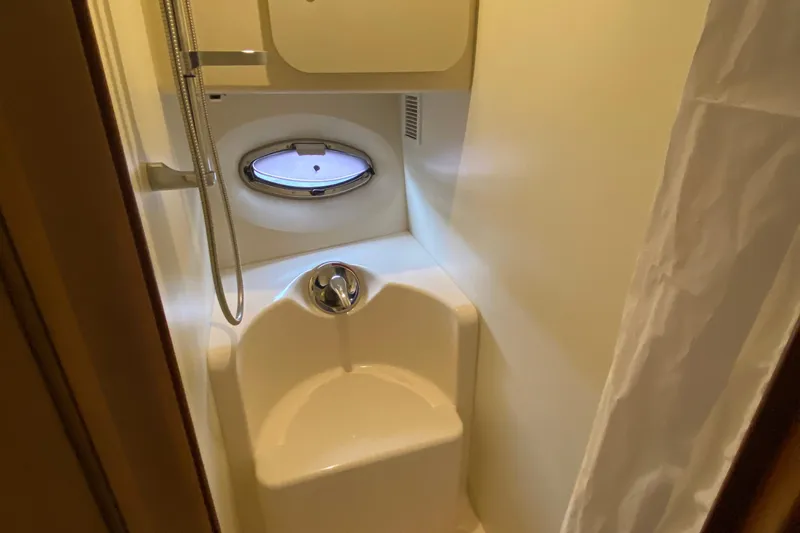 Carousel Yacht Photos Pics Compact bathroom in 2007 Silverton 36 Convertible yacht with shower and porthole window.