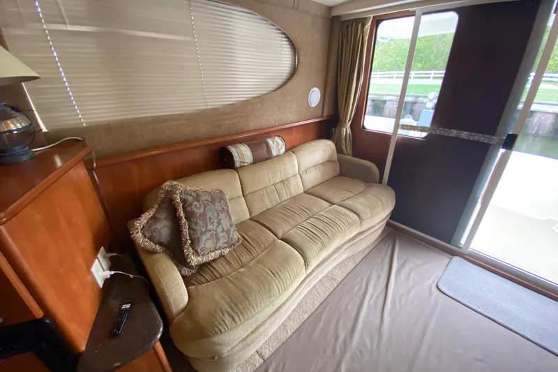 Carousel Yacht Photos Pics Interior of 2007 Silverton 36 Convertible yacht with beige sofa and decorative pillows.
