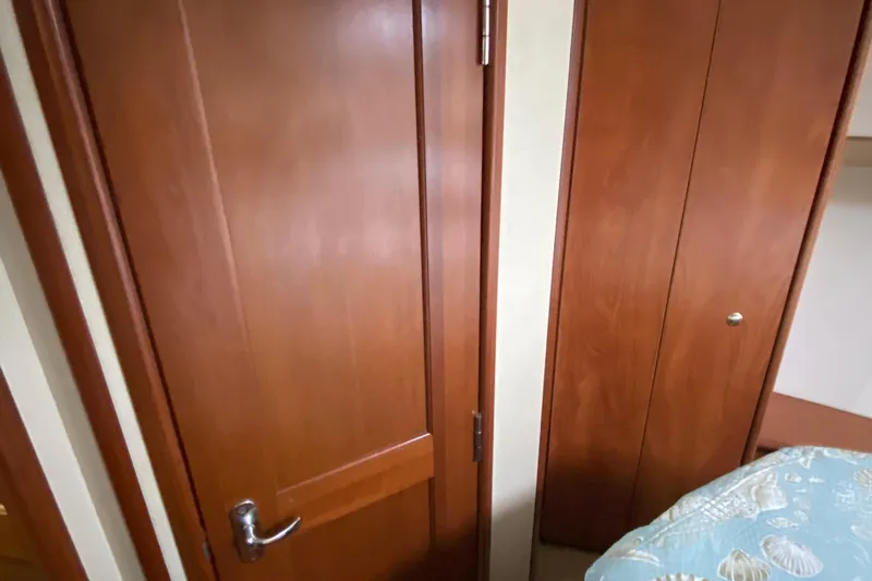 Carousel Yacht Photos Pics Interior of 2007 Silverton 36 Convertible with wooden doors and patterned bedding.