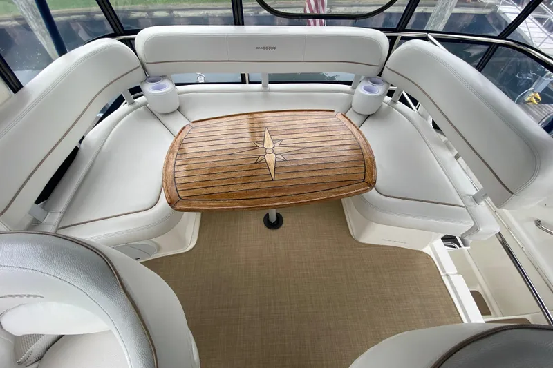 Carousel Yacht Photos Pics Luxurious seating area on 2007 Silverton 36 Convertible yacht with wooden table.