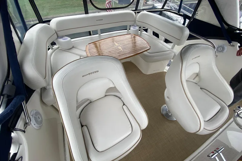 Carousel Yacht Photos Pics Luxurious seating area on a 2007 Silverton 36 Convertible yacht with elegant white upholstery.