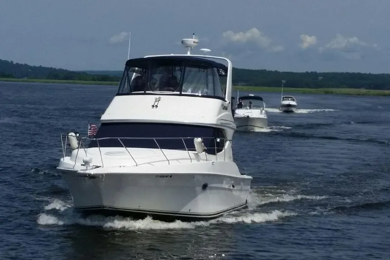 Carousel Yacht Photos Pics 2007 Silverton 36 Convertible yacht cruising on open water with scenic background.