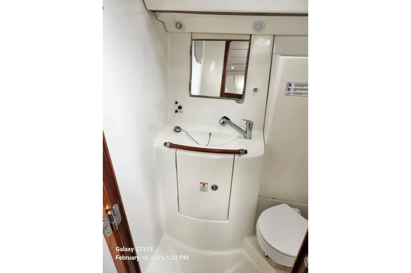 Little Su Yacht Photos Pics Bathroom interior of 2005 Beneteau Oceanis Clipper 393 yacht, featuring sink and mirror.