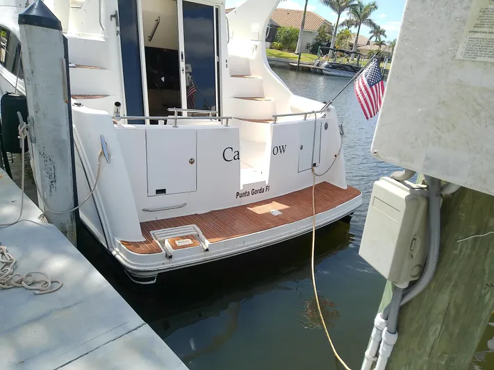 Cash Flow Yacht Photos Pics 2005 Carver 36 Mariner docked, displaying American flag, Punta Gorda, FL.
