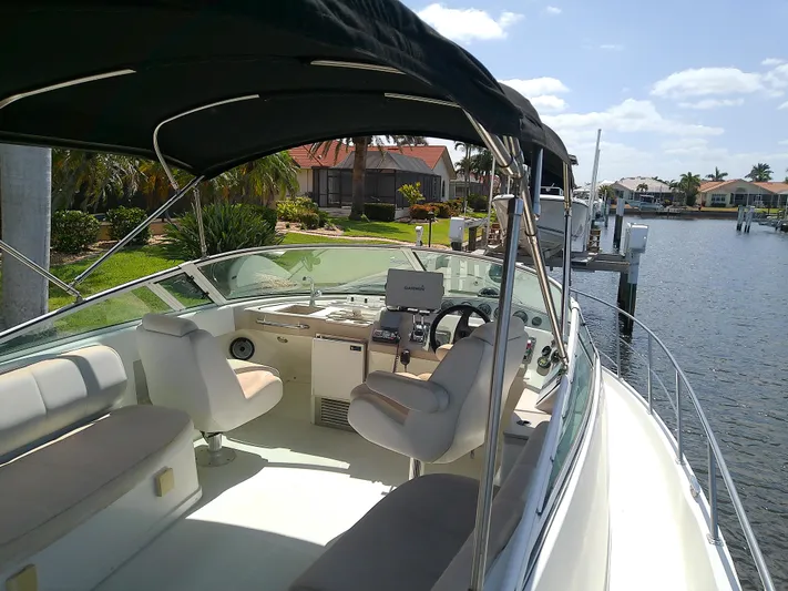 Cash Flow Yacht Photos Pics 2005 Carver 36 Mariner boat with spacious cockpit, docked by waterfront homes.