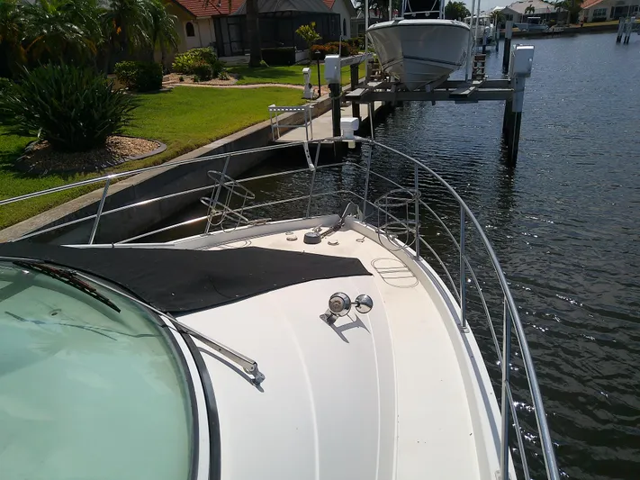 Cash Flow Yacht Photos Pics 2005 Carver 36 Mariner yacht docked by a canal with lush greenery.