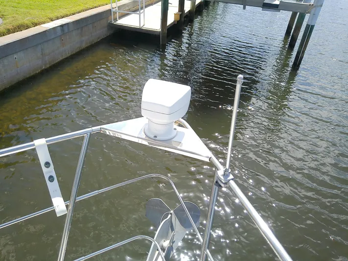 Cash Flow Yacht Photos Pics Bow of 2005 Carver 36 Mariner yacht with radar, docked by calm water.