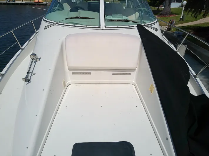 Cash Flow Yacht Photos Pics 2005 Carver 36 Mariner boat deck with seating, docked by the water.