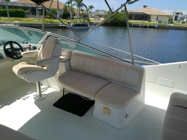 Cash Flow Yacht Photos Pics 2005 Carver 36 Mariner boat interior with seating and steering, docked by a waterfront.