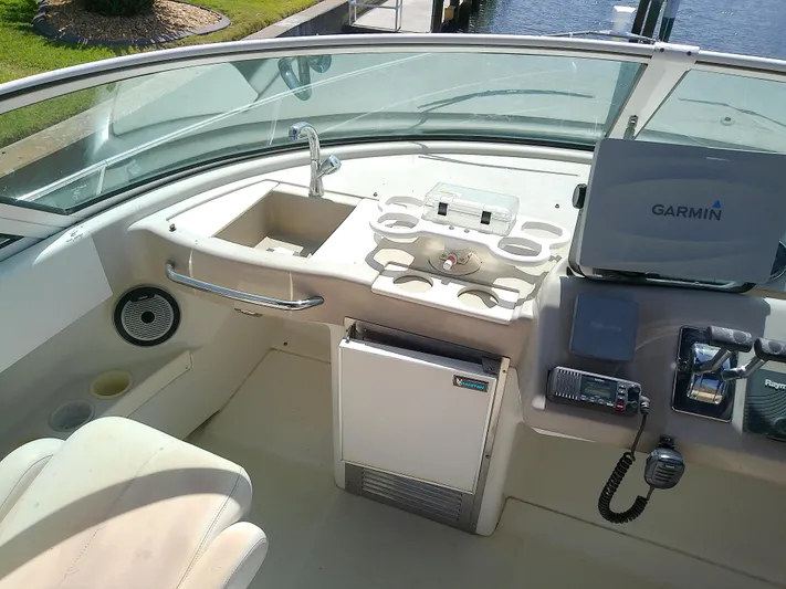 Cash Flow Yacht Photos Pics 2005 Carver 36 Mariner cockpit with Garmin navigation, sink, and seating area.