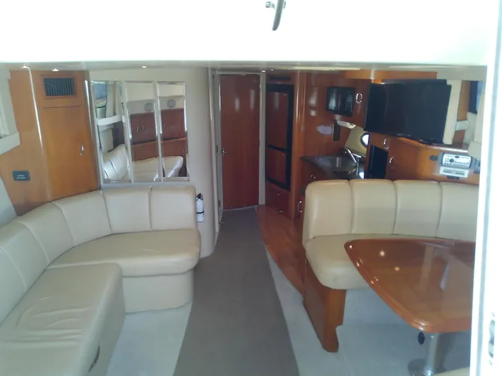 Cash Flow Yacht Photos Pics 2005 Carver 36 Mariner interior with beige seating, wooden table, and modern amenities.