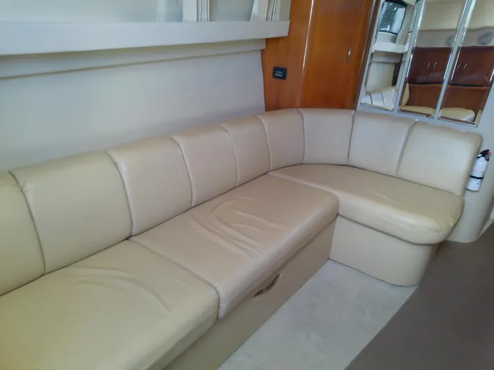 Cash Flow Yacht Photos Pics 2005 Carver 36 Mariner interior with beige leather seating and wooden accents.