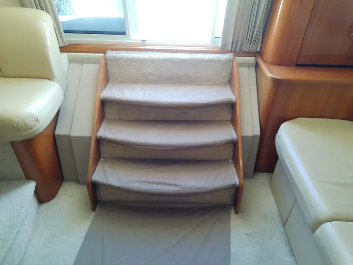 Cash Flow Yacht Photos Pics Interior stairs of 2005 Carver 36 Mariner yacht, featuring beige upholstery and wood accents.