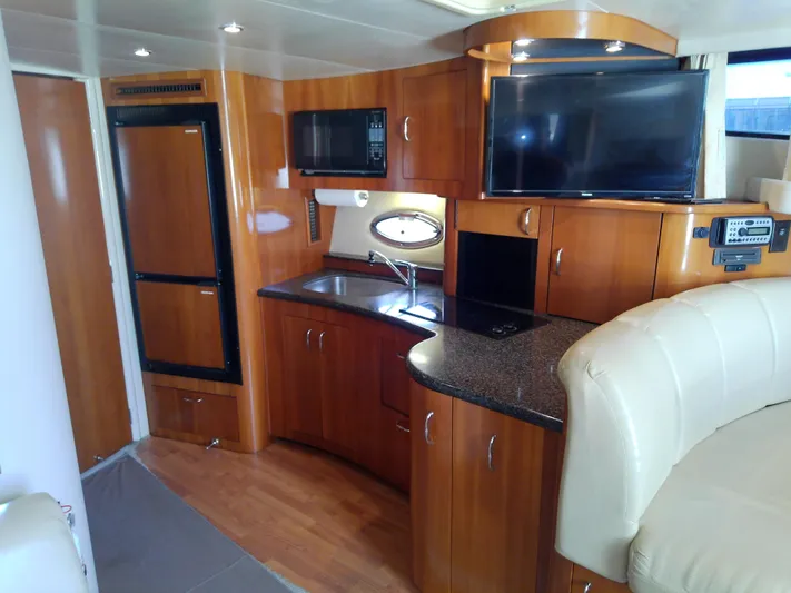 Cash Flow Yacht Photos Pics 2005 Carver 36 Mariner yacht interior with kitchen, TV, and seating area.