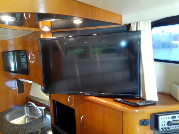 Cash Flow Yacht Photos Pics Interior of 2005 Carver 36 Mariner yacht with TV, microwave, and sink.