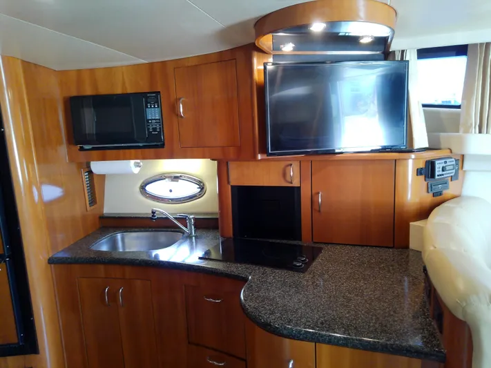 Cash Flow Yacht Photos Pics 2005 Carver 36 Mariner yacht kitchen with microwave, sink, and TV.