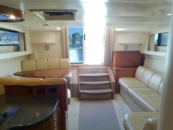 Cash Flow Yacht Photos Pics Interior of 2005 Carver 36 Mariner yacht with beige seating and wooden accents.