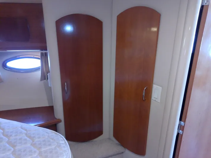 Cash Flow Yacht Photos Pics Interior of 2005 Carver 36 Mariner with wooden cabinets and porthole window.