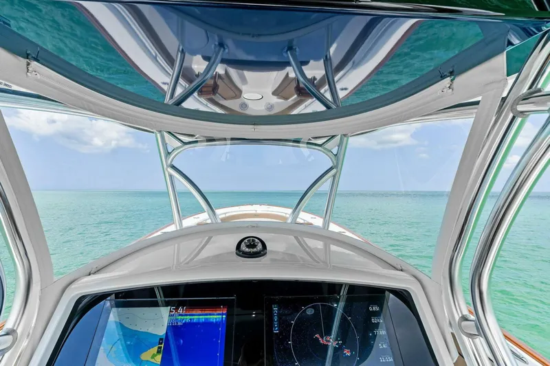 Galati Yacht Sales Trade Yacht Photos Pics 2024 Valhalla Boatworks V-37 helm view with navigation screens, overlooking clear ocean waters.