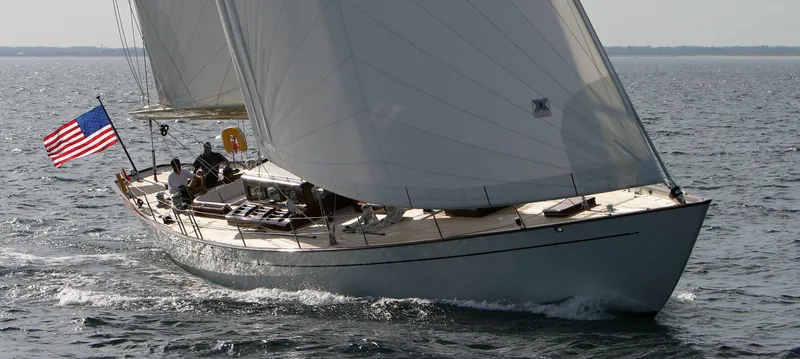 Aldebaran Yacht Photos Pics JFA Yachts Custom 70 sailing yacht, 2003 model, cruising on open water with American flag.