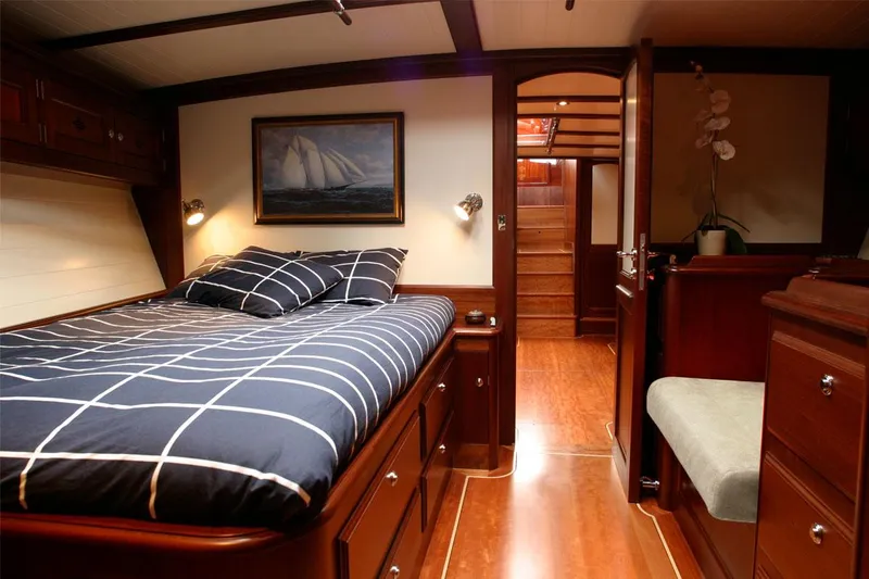 Aldebaran Yacht Photos Pics Luxurious cabin interior of 2003 JFA Yachts Custom 70 with wooden furnishings.