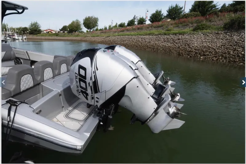 Yacht Photos Pics 2020 Midnight Express 37 Open boat with dual outboard engines on a calm river.