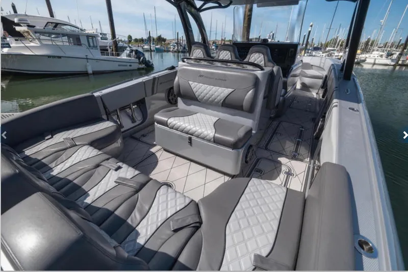  Yacht Photos Pics 2020 Midnight Express 37 Open boat interior with luxurious seating in a marina setting.