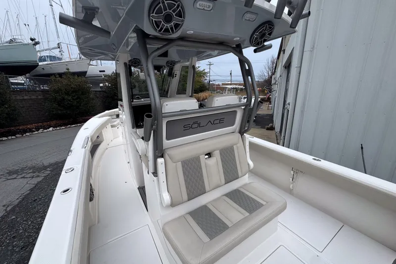  Yacht Photos Pics 2025 Solace 30 HCS boat interior with seating and console, docked near other vessels.