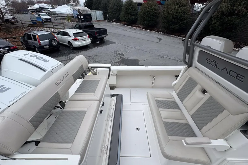  Yacht Photos Pics 2025 Solace 30 HCS boat interior with cushioned seating and Mercury engines.