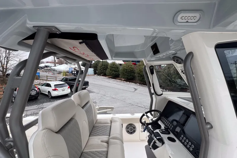  Yacht Photos Pics Interior view of 2025 Solace 30 HCS boat, featuring modern helm and seating.