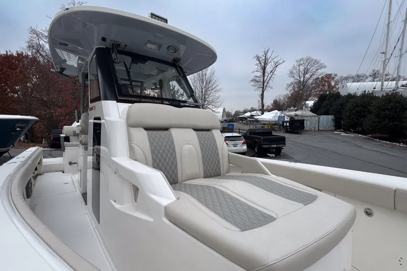  Yacht Photos Pics 2025 Solace 30 HCS boat with luxurious seating, docked outdoors.