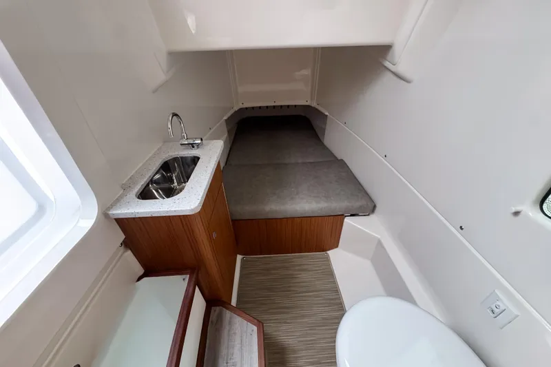  Yacht Photos Pics 2025 Solace 30 HCS cabin interior with sink, bed, and toilet.