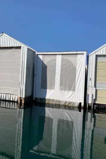  Yacht Photos Pics Covered dock for 2014 Ranger Tugs Trawler on calm water.