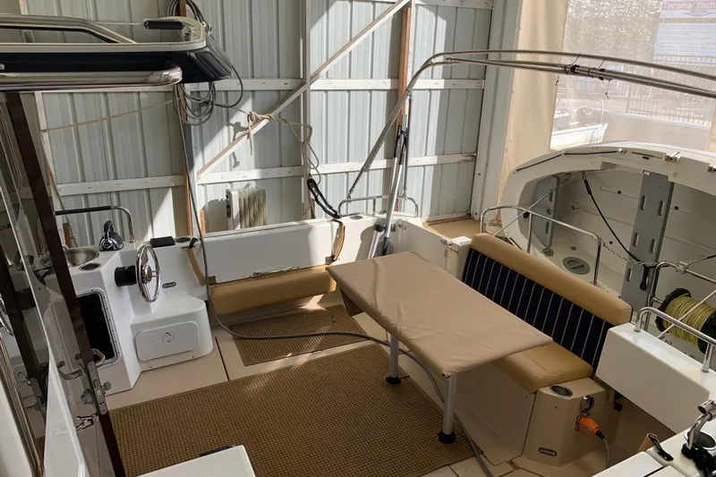  Yacht Photos Pics 2014 Ranger Tugs Trawler interior with seating and table in a covered dock.