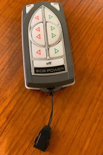  Yacht Photos Pics Remote control for 2014 Ranger Tugs Trawler boat on wooden surface.