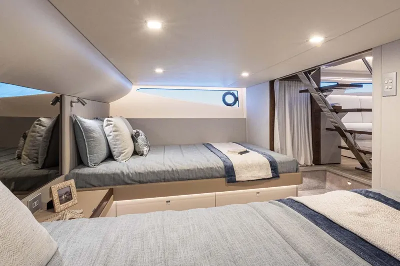 Yacht Photos Pics Manufacturer Provided Image: Luxurious cabin interior of 2026 Riviera 4300 Sport Express yacht with modern bedding and decor.