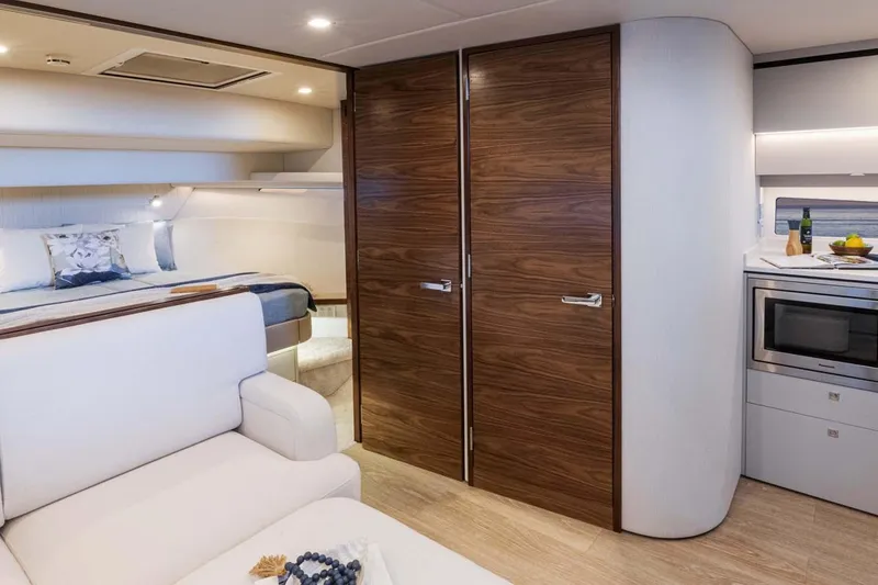  Yacht Photos Pics Manufacturer Provided Image: Luxurious interior of 2026 Riviera 4300 Sport Express yacht with modern kitchen and cozy bedroom.