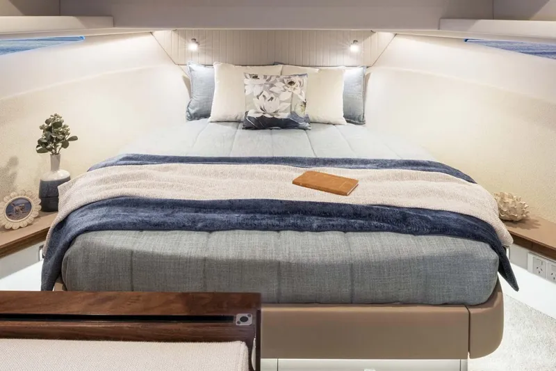  Yacht Photos Pics Manufacturer Provided Image: Luxurious bedroom interior of 2026 Riviera 4300 Sport Express yacht, featuring elegant bedding and decor.