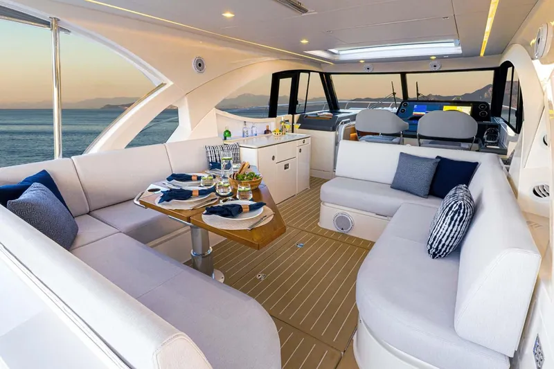  Yacht Photos Pics Manufacturer Provided Image: Luxurious interior of 2026 Riviera 4300 Sport Express yacht with elegant seating and dining area.