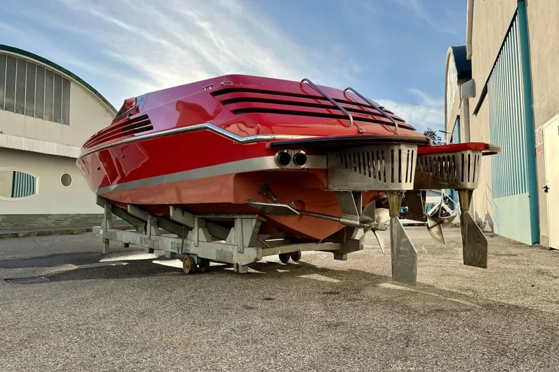  Yacht Photos Pics Red 1994 Riva 32 Ferrari Special boat on a trailer, showcasing sleek design and dual propellers.