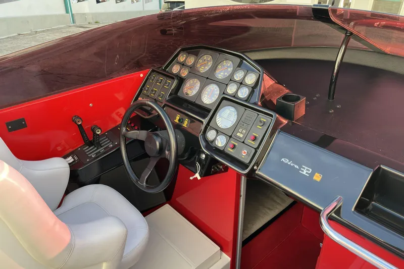  Yacht Photos Pics Interior of a 1994 Riva 32 Ferrari Special boat with red dashboard and gauges.