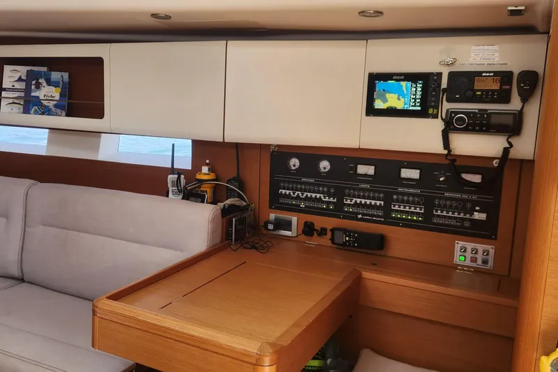 Nemo Yacht Photos Pics Interior of 2015 Grand Soleil 47 yacht with navigation equipment and seating area.