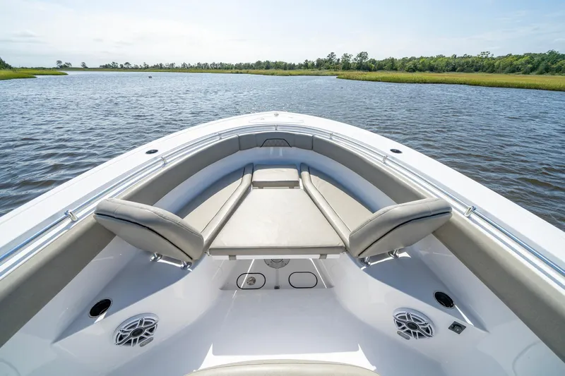  Yacht Photos Pics 2023 Sportsman Open 282 Center Console boat on calm water, featuring spacious seating.