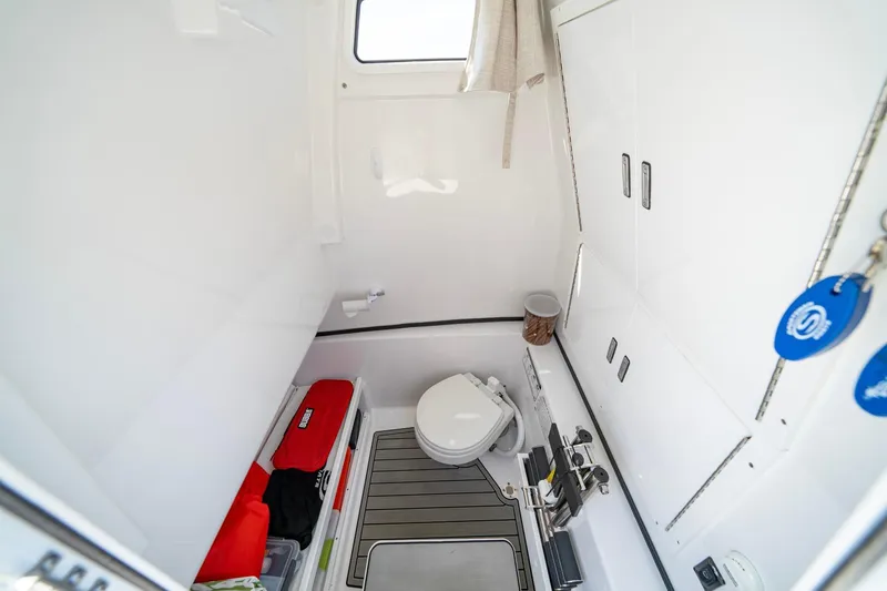  Yacht Photos Pics 2023 Sportsman Open 282 Center Console boat interior with toilet and storage.