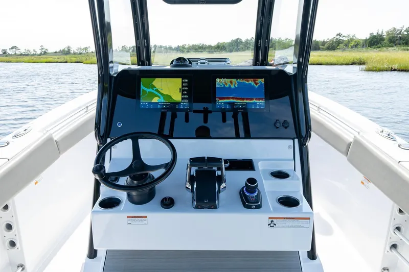  Yacht Photos Pics 2023 Sportsman Open 282 Center Console dashboard with navigation screens and steering wheel.