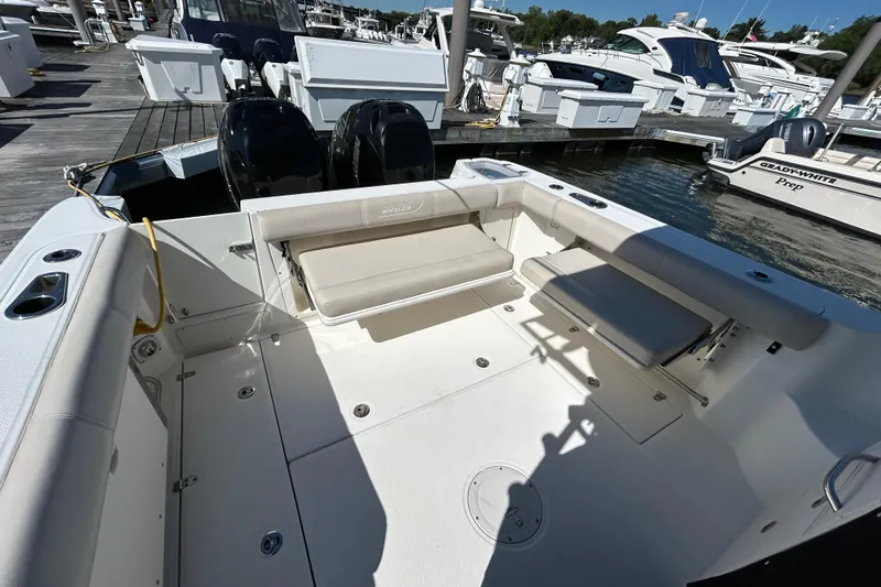  Yacht Photos Pics 2015 Boston Whaler 285 Conquest boat interior with seating and twin engines at marina.