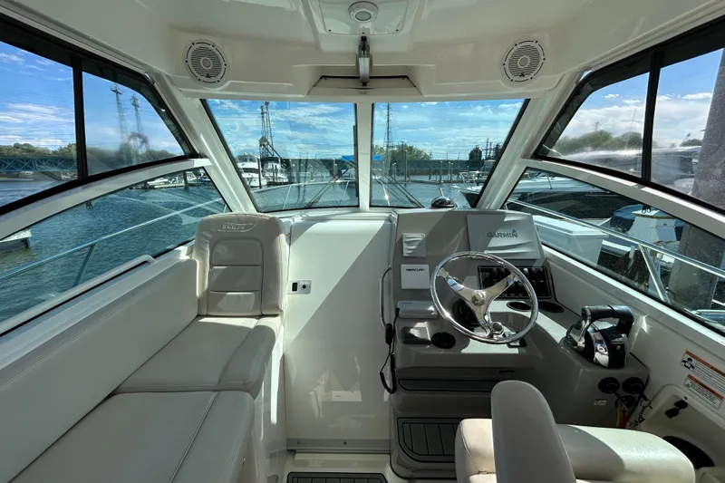  Yacht Photos Pics 2015 Boston Whaler 285 Conquest helm with Garmin navigation, docked at marina.