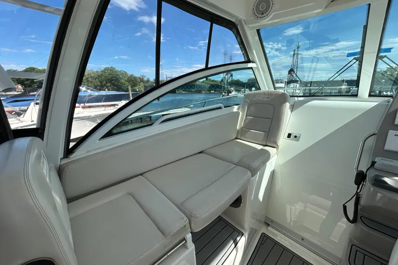  Yacht Photos Pics Interior of 2015 Boston Whaler 285 Conquest boat with seating and windows.