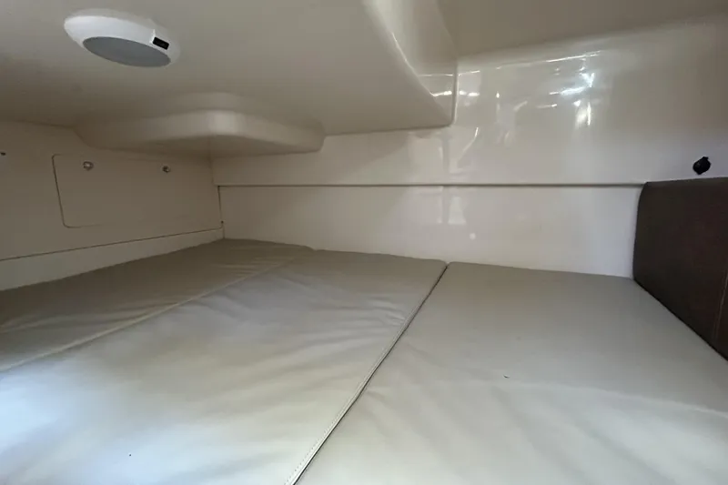  Yacht Photos Pics 2015 Boston Whaler 285 Conquest cabin interior with cushioned sleeping area.