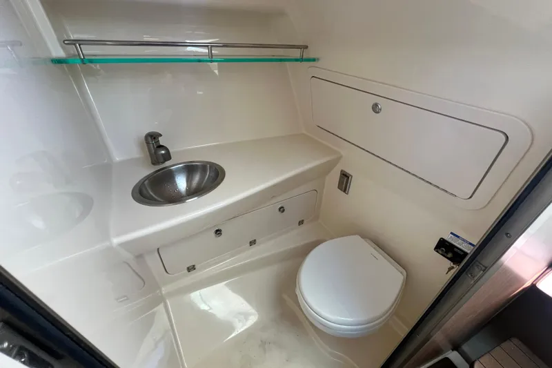  Yacht Photos Pics 2015 Boston Whaler 285 Conquest boat bathroom with sink and toilet.